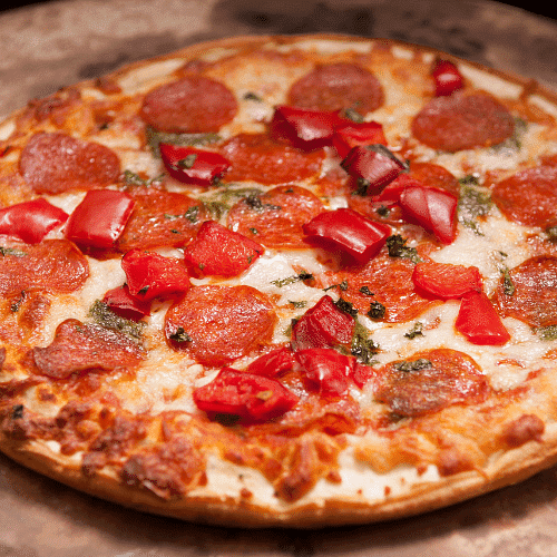 Pepperoni pizza topped with fresh diced tomatoes and herbs on a wood-fired crust.